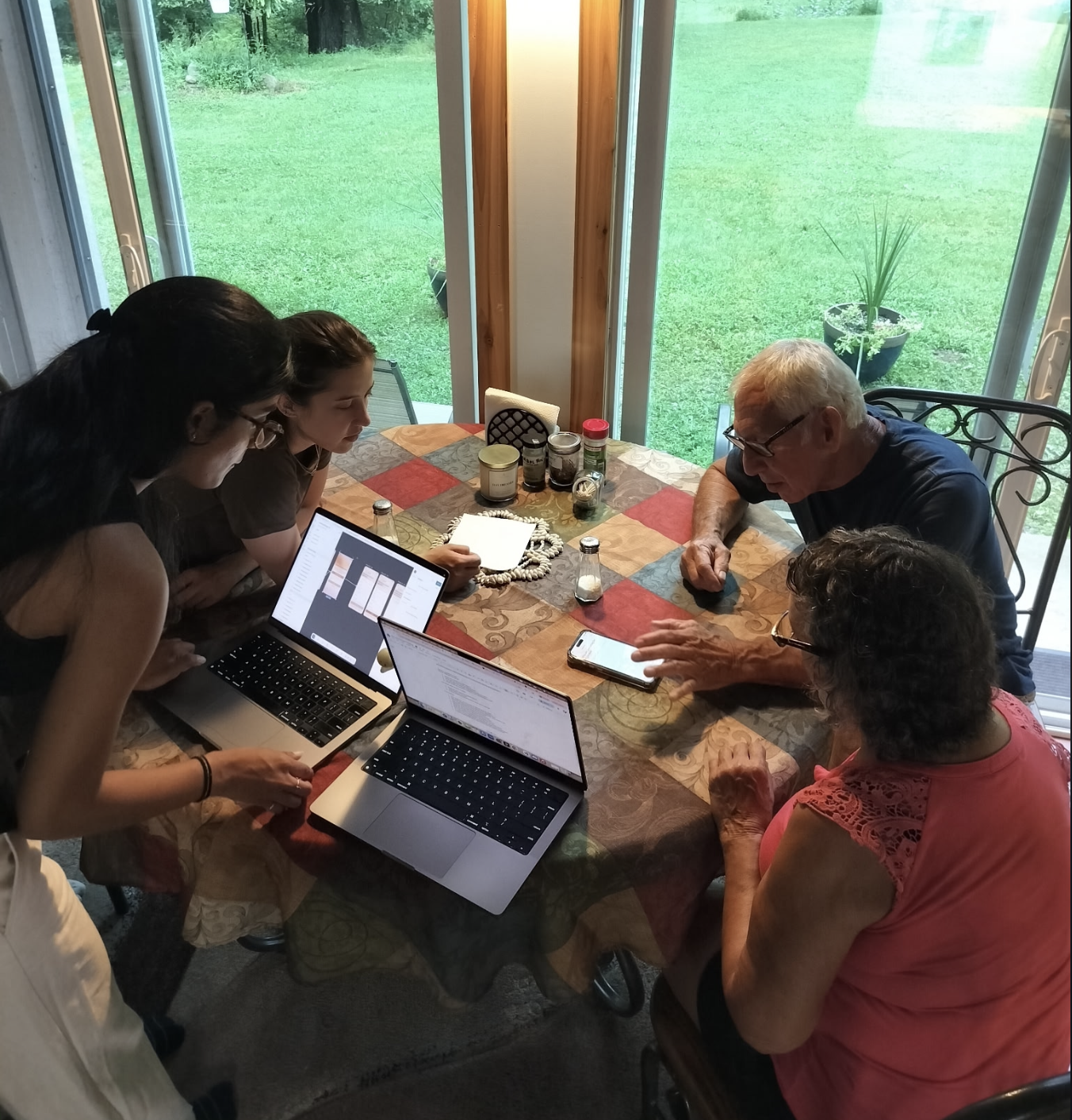 Early usability testing: two team members walking caregivers through the Care2Care prototype on laptops